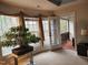 Bright bedroom with large windows, stylish curtains, and access to outdoor porch at 502 Willowmere Ct, Cary, NC 27513