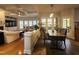 Bright dining area features a wooden table, patterned chairs, and a view to the outside deck through large windows at 502 Willowmere Ct, Cary, NC 27513