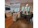 This open floor plan features a modern dining table with decorative chairs and hardwood flooring at 502 Willowmere Ct, Cary, NC 27513