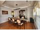 Elegant dining room featuring a chandelier, hardwood floors, and a china cabinet at 502 Willowmere Ct, Cary, NC 27513