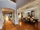 Dining room featuring an elegant chandelier, hardwood floors, and access to the living room at 502 Willowmere Ct, Cary, NC 27513