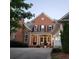 Charming brick home features a welcoming front porch and inviting facade at 502 Willowmere Ct, Cary, NC 27513