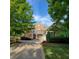 Charming two-story brick home featuring a welcoming front porch and lush landscaping at 502 Willowmere Ct, Cary, NC 27513