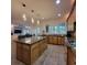 Well-lit kitchen featuring a large island, tiled floors, and stainless steel sink at 502 Willowmere Ct, Cary, NC 27513