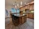 Kitchen with island, cooktop, tile backsplash, and stainless appliances at 502 Willowmere Ct, Cary, NC 27513