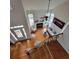 A living room featuring hardwood floors, a fireplace, large windows, and access to the staircase at 502 Willowmere Ct, Cary, NC 27513