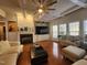 Cozy living room with a fireplace, built-in shelving, hardwood floors, and large windows for plenty of natural light at 502 Willowmere Ct, Cary, NC 27513
