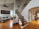 Open-concept living room featuring a staircase, hardwood floors, and a seating area at 502 Willowmere Ct, Cary, NC 27513