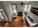 Bright living room with fireplace, hardwood floors, large windows, and neutral decor at 502 Willowmere Ct, Cary, NC 27513