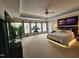Bright main bedroom with decorative trey ceiling, balcony access, and view of the flat screen TV at 502 Willowmere Ct, Cary, NC 27513