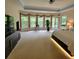 Large main bedroom featuring tray ceilings, lots of windows, and a private entrance to the backyard at 502 Willowmere Ct, Cary, NC 27513