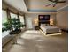 Bright and airy main bedroom features a decorative tray ceiling, balcony, and a king bed at 502 Willowmere Ct, Cary, NC 27513