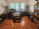 Spacious home office with hardwood floors, multiple workstations, and natural light from large windows at 502 Willowmere Ct, Cary, NC 27513