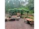 Inviting brick patio featuring a wisteria-covered pergola and comfortable seating area at 502 Willowmere Ct, Cary, NC 27513