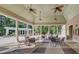 Outdoor pool area with covered seating, fireplace and adjacent structure at 502 Willowmere Ct, Cary, NC 27513