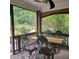 Inviting screened porch with a dining table and comfortable seating perfect for enjoying the outdoors at 502 Willowmere Ct, Cary, NC 27513