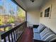 Relaxing porch featuring cushioned seating and a view of landscaped yard at 502 Willowmere Ct, Cary, NC 27513