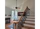 View of the staircase and fireplace in this home with hardwood stairs and decorative spindles at 502 Willowmere Ct, Cary, NC 27513