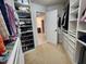 Organized walk-in closet with custom shelving for clothes, shoes and accessories at 502 Willowmere Ct, Cary, NC 27513