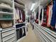 Spacious walk-in closet features custom shelving and storage drawers for organized wardrobe at 502 Willowmere Ct, Cary, NC 27513