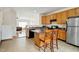 Inviting kitchen with an island, wooden cabinetry, and stainless steel appliances at 5163 Sandy Banks Rd, Raleigh, NC 27616