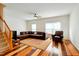Open living room showcasing a large sectional sofa, hardwood floors, and ample natural light at 5163 Sandy Banks Rd, Raleigh, NC 27616