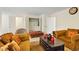 Cozy living room with comfortable seating, a decorative ottoman, and neutral carpeting at 5163 Sandy Banks Rd, Raleigh, NC 27616