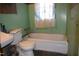 Modest bathroom featuring a combination tub and shower unit, and a classic toilet at 537 Homeland Ave, Durham, NC 27707