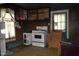Dated kitchen with old appliances and dark wood walls at 537 Homeland Ave, Durham, NC 27707