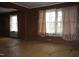 Spacious room with wood walls and window with sheer curtains at 537 Homeland Ave, Durham, NC 27707
