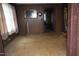 Empty living room with wood paneling and a view into another room at 537 Homeland Ave, Durham, NC 27707