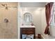 Bathroom with a tiled shower and a vanity with a round mirror that is above the sink at 5500 Fortunes Ridge Dr # 72A, Durham, NC 27713