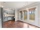 Kitchen with stainless steel appliances, gray painted cabinets, hardwood flooring, and a door to an outdoor deck at 5500 Fortunes Ridge Dr # 72A, Durham, NC 27713