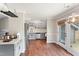 Bright kitchen and dining area features grey cabinets, stainless appliances, hardwood floors, and access to a deck at 5500 Fortunes Ridge Dr # 72A, Durham, NC 27713