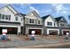 Row of new two-story townhomes with two-car garage in a new community development at 6002 Shade Tree Ln, Durham, NC 27703