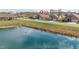 Aerial view showcasing the neighborhood pond, street, and home location at 667 Ashley Woods Dr, Gibsonville, NC 27249