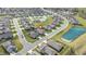 An aerial view highlights the community, pond, and nearby amenities at 667 Ashley Woods Dr, Gibsonville, NC 27249