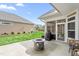Backyard includes a stone fire pit, screened patio, and green space at 667 Ashley Woods Dr, Gibsonville, NC 27249