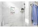 Bright bathroom shower featuring elegant white tile and recessed shelving for toiletries at 667 Ashley Woods Dr, Gibsonville, NC 27249