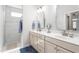 Bright bathroom featuring double sinks, a walk-in shower, and modern fixtures at 667 Ashley Woods Dr, Gibsonville, NC 27249