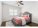 Cozy bedroom with a ceiling fan, plush bed, and a view from the window at 667 Ashley Woods Dr, Gibsonville, NC 27249