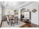Charming dining room features a coffered ceiling, stylish lighting, and rich hardwood floors at 667 Ashley Woods Dr, Gibsonville, NC 27249
