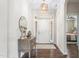 Welcoming entryway featuring hardwood floors, a stylish console table, and an elegant light fixture at 667 Ashley Woods Dr, Gibsonville, NC 27249