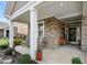 Inviting front porch, adorned with stone accents and relaxing seating at 667 Ashley Woods Dr, Gibsonville, NC 27249