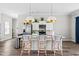 Kitchen featuring white cabinetry, stainless appliances, granite counters, pendant lighting, and barstool seating at 667 Ashley Woods Dr, Gibsonville, NC 27249