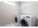Bright laundry room featuring a modern, white washer and dryer with convenient overhead shelving at 667 Ashley Woods Dr, Gibsonville, NC 27249