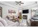 Inviting living room with a fireplace, ceiling fan, and comfortable seating arrangement at 667 Ashley Woods Dr, Gibsonville, NC 27249