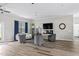 Bright living room with modern furnishings, TV, fireplace, and beautiful luxury vinyl plank flooring at 667 Ashley Woods Dr, Gibsonville, NC 27249