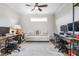 A spacious home office with a comfortable sofa and two workstations at 667 Ashley Woods Dr, Gibsonville, NC 27249
