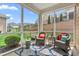 Relaxing screened patio features outdoor seating and a vibrant area rug at 667 Ashley Woods Dr, Gibsonville, NC 27249